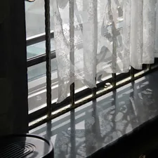 a window with white curtains and a fan related to Kitchen Valance Curtains