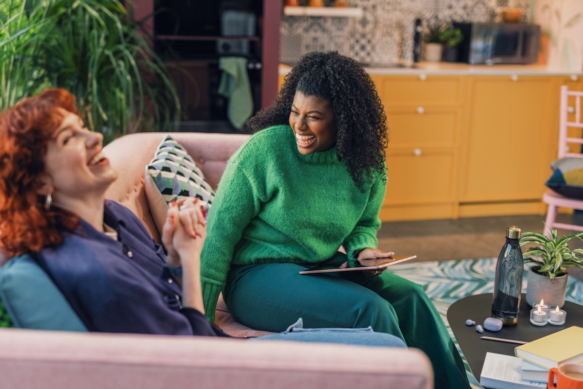 a woman and a man sitting on a couch related to Discovering Comfort and Style: Value City Furniture Beds