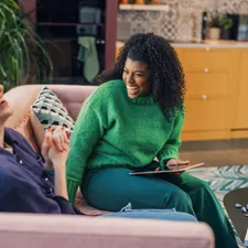 a woman and a man sitting on a couch related to Discovering Comfort and Style: Value City Furniture Beds
