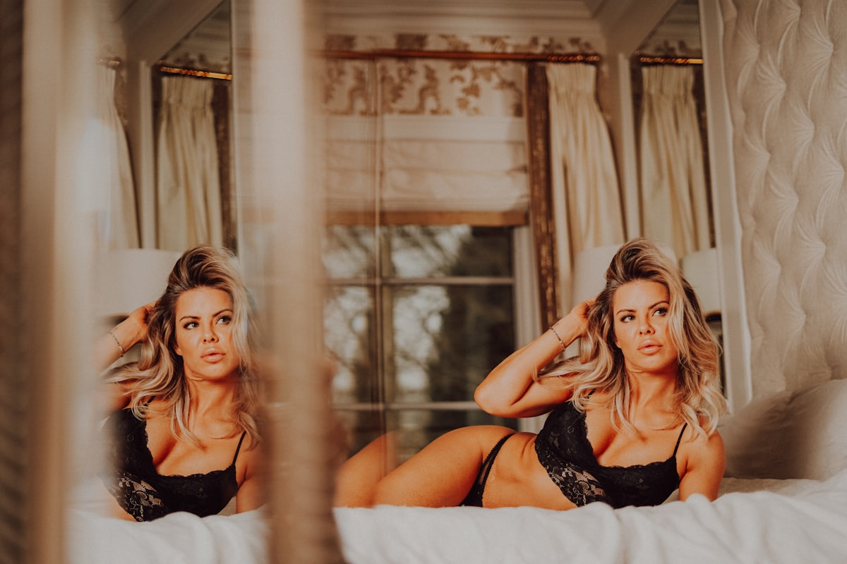 a woman in a black lingerie sitting on a bed related to Measuring the Majesty: Dimensions of a Queen Size Bed