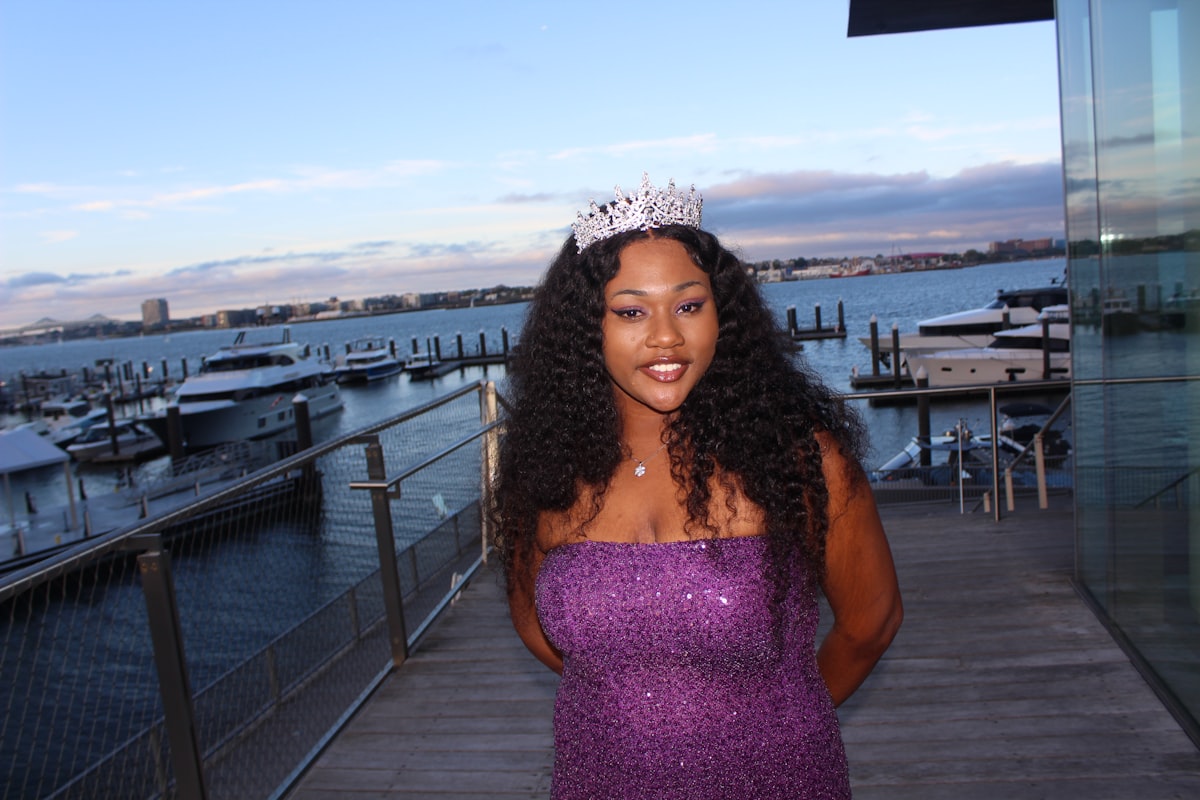 A woman in a purple dress standing on a dock related to Understanding Queen Size Beds: Dimensions and Benefits