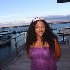 A woman in a purple dress standing on a dock related to Understanding Queen Size Beds: Dimensions and Benefits