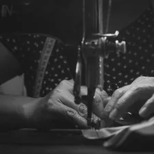 a woman is using a sewing machine to sew related to How to Make No Sew Valances