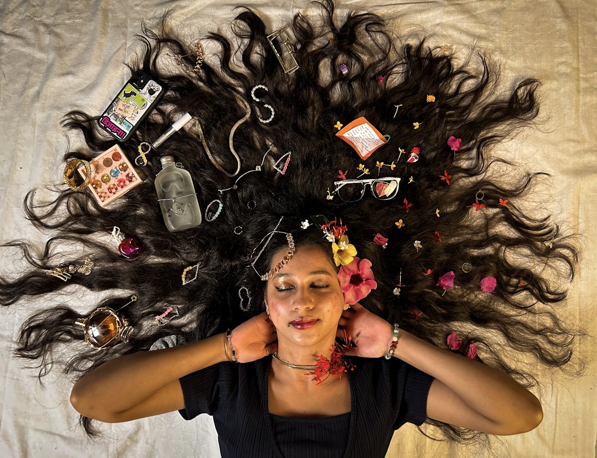a woman laying on top of a bed covered in hair related to Unlock Your Best Hair Yet with Bed Head Colour Goddess: The Ultimate Guide