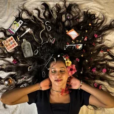 a woman laying on top of a bed covered in hair related to Unlock Your Best Hair Yet with Bed Head Colour Goddess: The Ultimate Guide