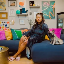 a woman sitting on a couch with a dog related to Styling Your Home with a Pop of Color: The Red Scarf Valance