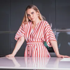 A woman standing by the kitchen related to Red Kitchen Valance: A Pop of Color for Your Kitchen