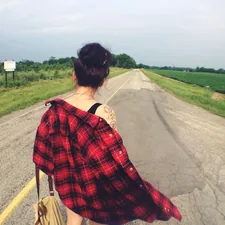 a woman walking down a road with a handbag related to Red Plaid Valance