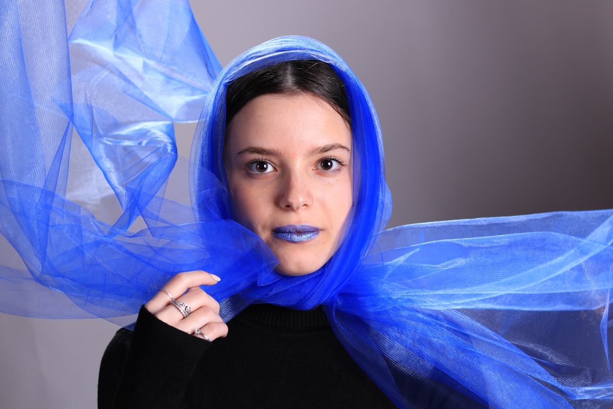 a woman with a blue scarf around her head related to Sheer Scarf Valances