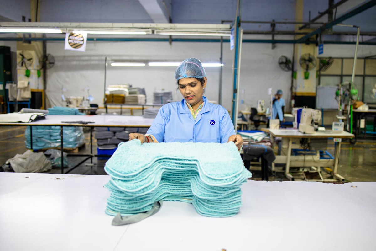 A woman works in a factory related to The Ultimate Guide to Disposable Bed Pads: Comfort and Convenience