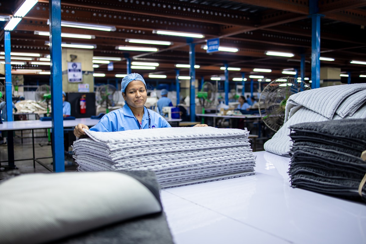 A woman works with textiles in a factory. related to From Factory Floors to Cozy Canine Corner: The Dallas Manufacturing Company Creating Custom Dog Beds