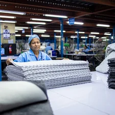 A woman works with textiles in a factory. related to From Factory Floors to Cozy Canine Corner: The Dallas Manufacturing Company Creating Custom Dog Beds
