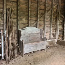 a wooden bench sitting in the middle of a room related to Stylish Entryways: 4 Unique Country Entryway Bench Designs