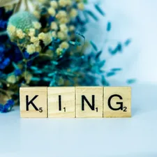 a wooden block that says king next to a bouquet of flowers related to Choose the Perfect King Size Quilt Coverlet for Your Bedroom Oasis