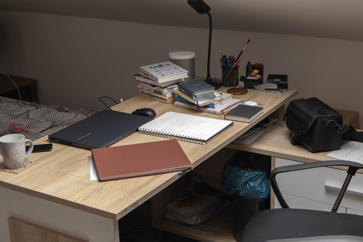 a wooden desk topped with a laptop computer related to Maximize Your Space with a Loft Bed and Desk: The Ultimate Study Solution