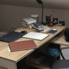 a wooden desk topped with a laptop computer related to Maximize Your Space with a Loft Bed and Desk: The Ultimate Study Solution