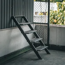 A wooden ladder leans against a wall. related to Assembling the Perfect Bunk Bed: A Step-by-Step Guide