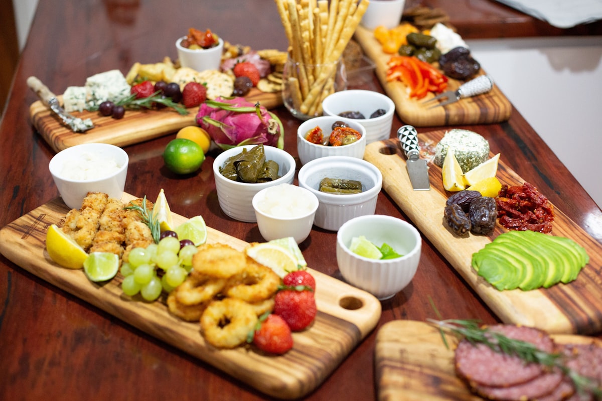 a wooden table topped with different types of food related to The Ultimate Guide to Teak Buffet Sideboards