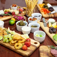 a wooden table topped with different types of food related to The Ultimate Guide to Teak Buffet Sideboards