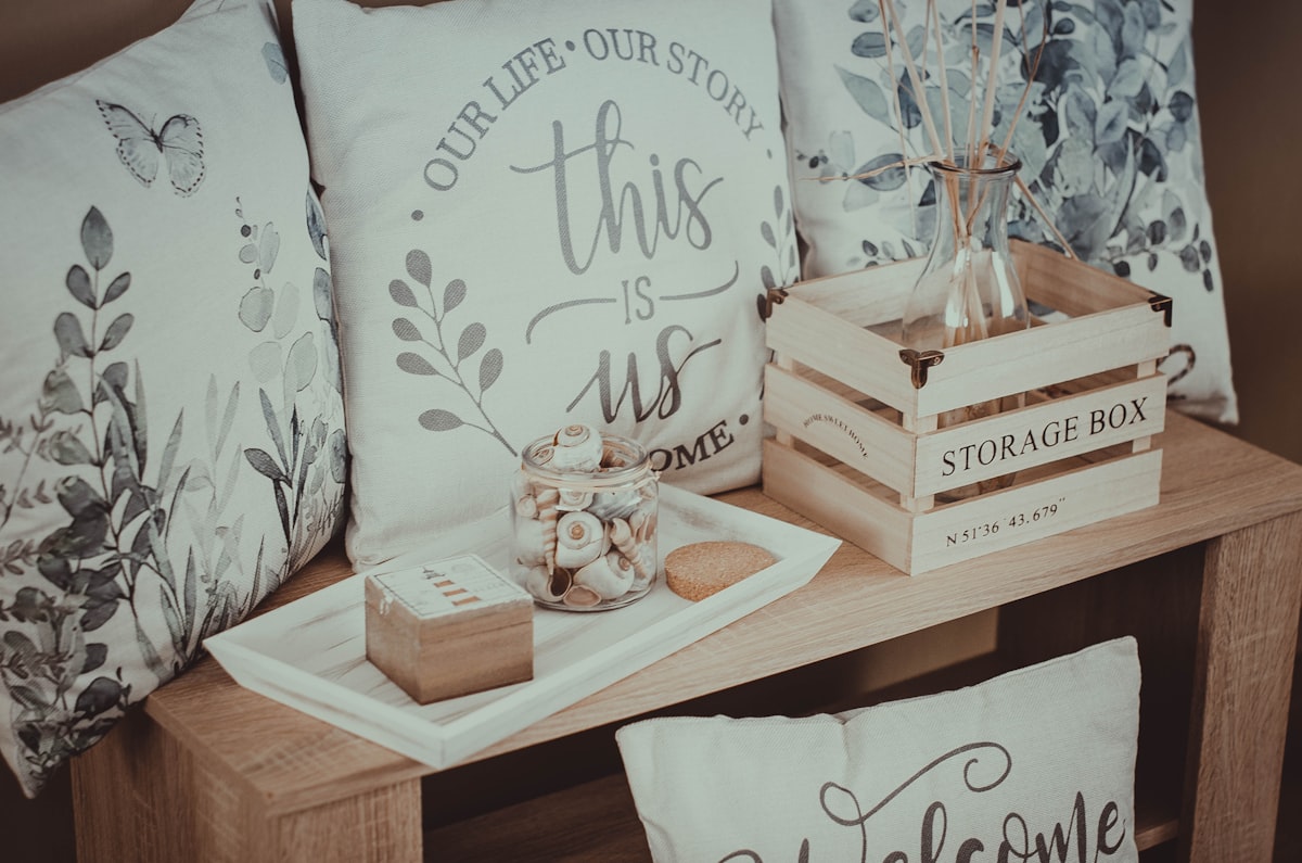 A wooden table topped with lots of pillows related to Elevate Your Home Decor: A Guide to Kmart Curtains and Valances