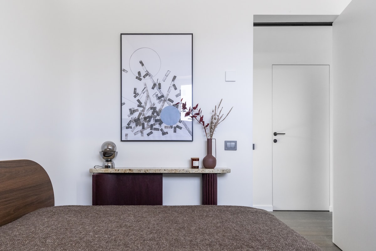 Accent colors—primarily deep red and rust—are introduced through furniture and textiles, adding visual contrast without disrupting the overall balance. related to Sleek and Sophisticated: The Ultimate Guide to Mid Century Modern Beds