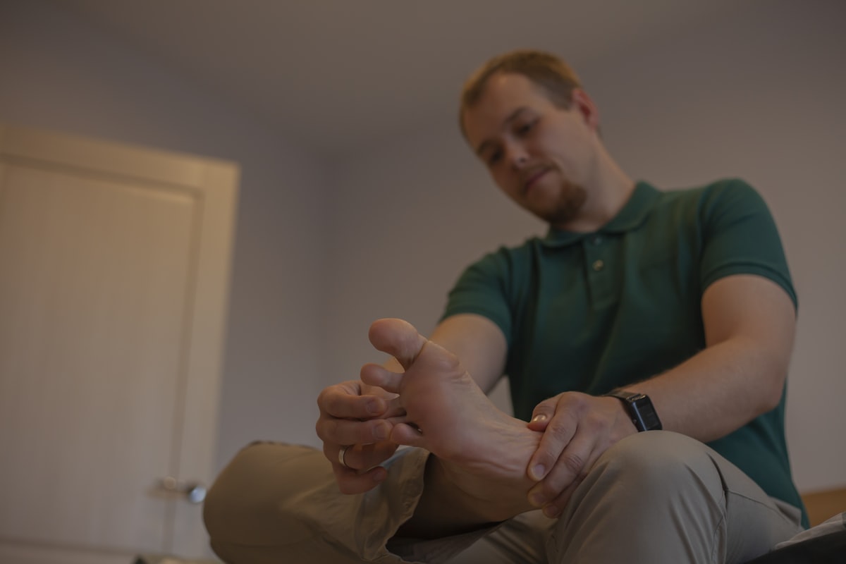 Adult man examines his own foot. Orthopedic problems concept. related to Understanding Leg Pain at Night in Bed
