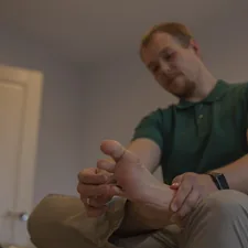 Adult man examines his own foot. Orthopedic problems concept. related to Understanding Leg Pain at Night in Bed