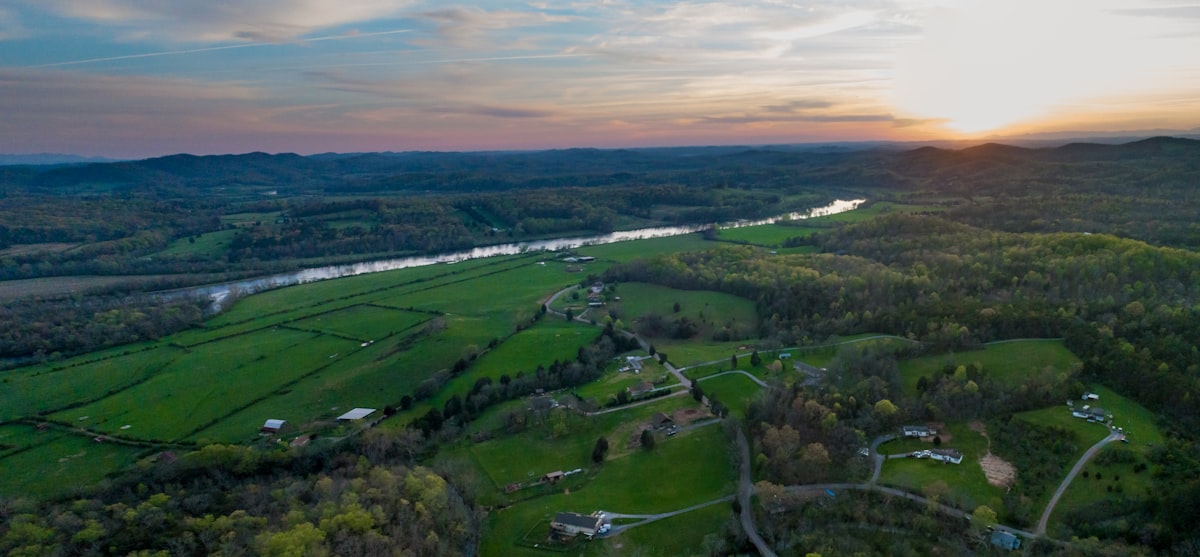 aerial photo of grass field during daytime related to Explore Cozy Stays in Knoxville, TN