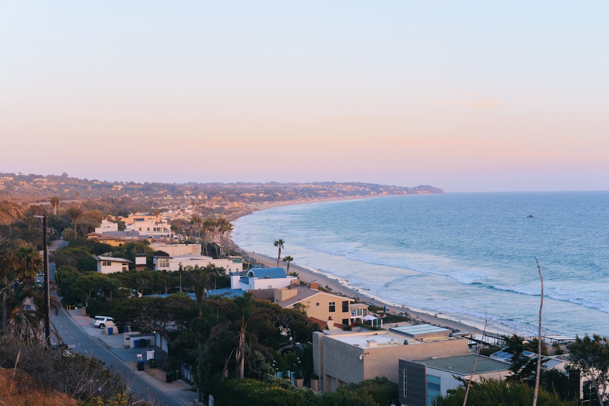 aerial photography of houses near beach related to Experience the Charm of a Cozy Coastal Escape