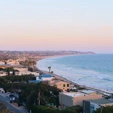 aerial photography of houses near beach related to Experience the Charm of a Cozy Coastal Escape
