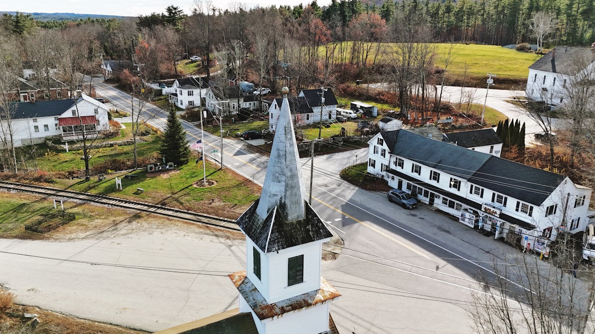 Aerial view of a small town with a church steeple. related to Discover the Charm of Bed and Breakfasts in New Hampshire
