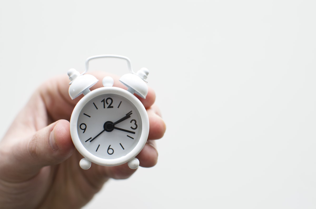 Alarm clock friends situation with hand related to The Sweet Spot: What Time Do I Need to Go to Bed?