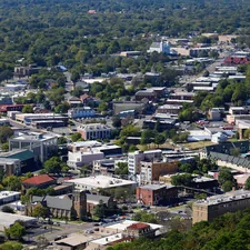 an aerial view of a city with lots of trees related to Charming Retreats in Hot Springs, Arkansas