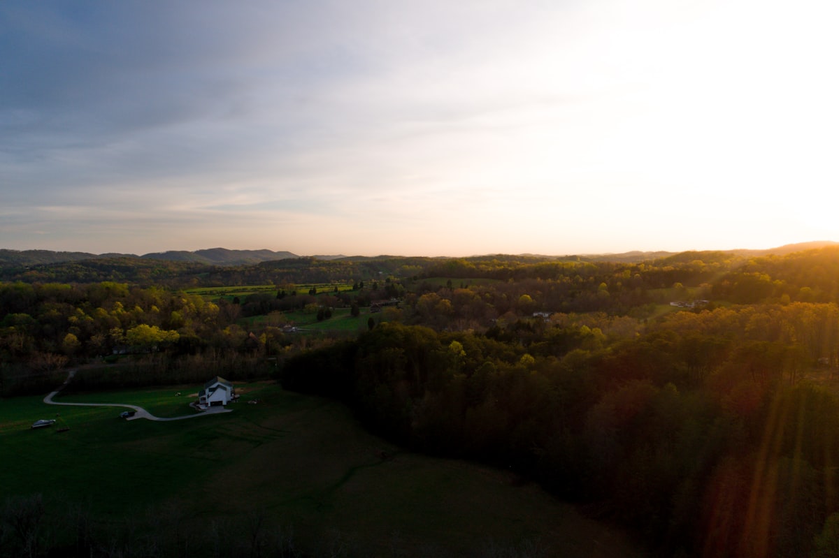 an aerial view of a field with a house in the distance related to Explore Cozy Stays in Knoxville, TN