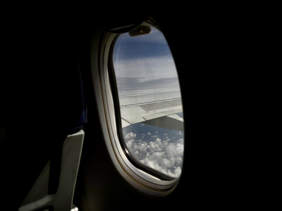 an airplane window looking out at the earth related to Valances for Wide Windows: Perfecting Your View