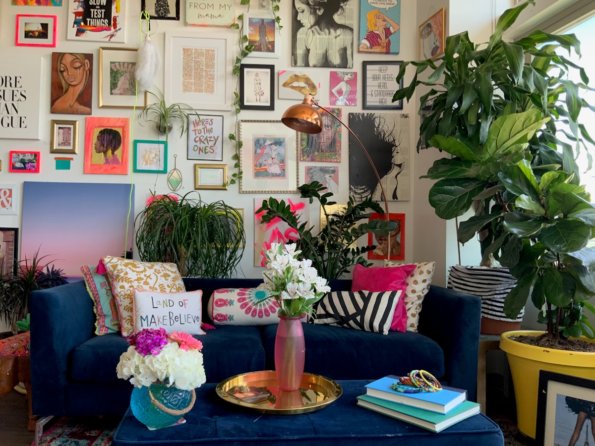 An eclectic gallery wall in a colorful maximalist apartment home in Denver, Colorado  related to Styling Your Home with a Pop of Color: The Red Scarf Valance