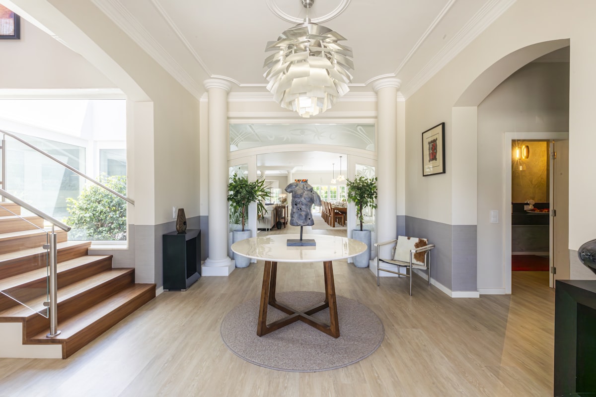An elegant entryway with a staircase and chandelier. related to Half Table Entryway