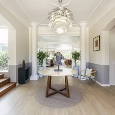 An elegant entryway with a staircase and chandelier. related to Half Table Entryway