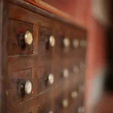 An old, wooden cabinet with several drawers. related to Elegant Antique Sideboards for Your Dream Home
