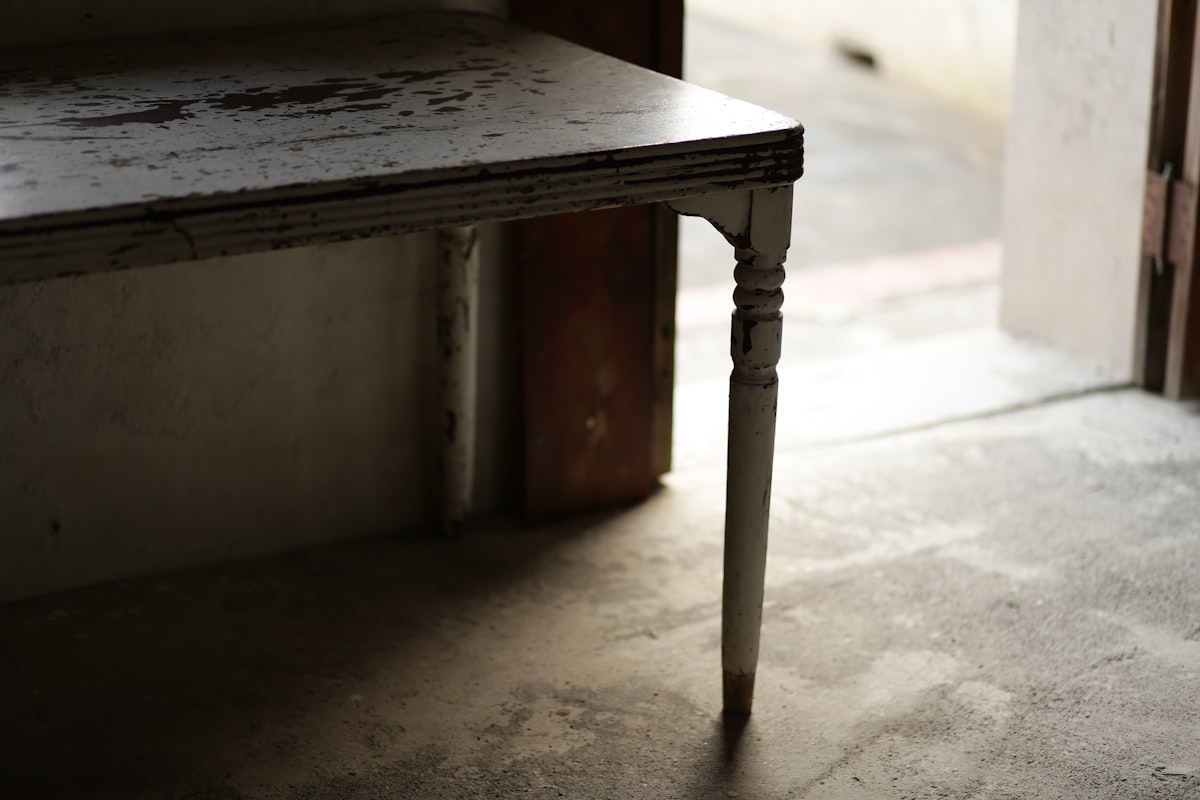 An old wooden table with a single leg. related to Half Table Entryway