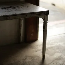 An old wooden table with a single leg. related to Half Table Entryway