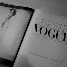 an open book with a picture of a woman in a dress related to Unveiling Luxury: The Enduring Appeal of Yves Delorme Coverlets