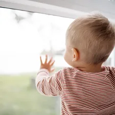 Baby Boy looking out the window related to Top Tips for Choosing the Perfect Kids Window Valance
