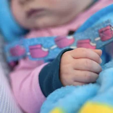 baby in blue and pink shirt related to A Perfect Match: Pink and Turquoise Crib Bedding