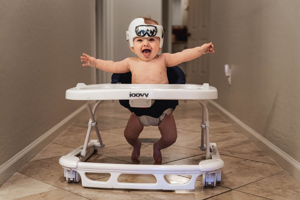 baby in white goggles on white and blue high chair related to Baby on the Move: The Ultimate Guide to Eddie Bauer Infant Travel Bed