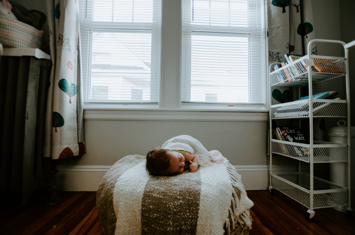 baby sleeping on gray and white bed related to Adorable Valances for Baby Room: Add a Touch of Cuteness