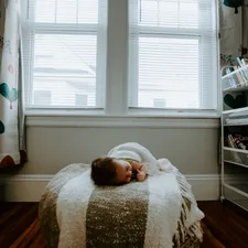 baby sleeping on gray and white bed related to Adorable Valances for Baby Room: Add a Touch of Cuteness