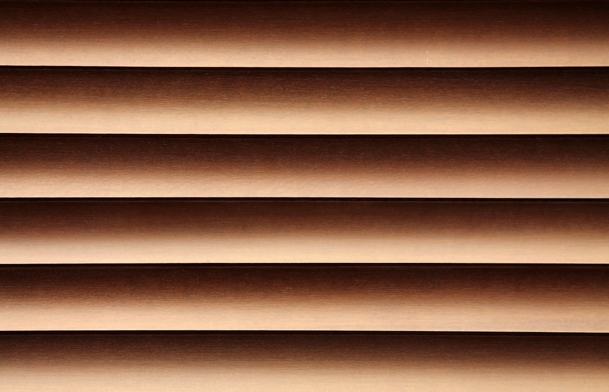 Beauty and harmony can be found in little things. Here light and shadow are playing with a wooden shade. related to Brown Window Valance: Elevate Your Home Decor