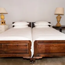 Bedroom in a farm cottage with a bedside lamps on bedside tables related to Elegant White Coverlets for Twin Beds