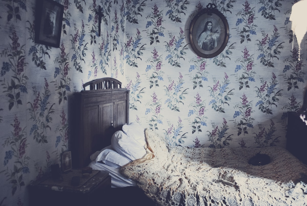 beige bedspread on brown wooden bed frame inside the room with photo frame related to Cozy Up Your Bedroom with Country Bedding Sets